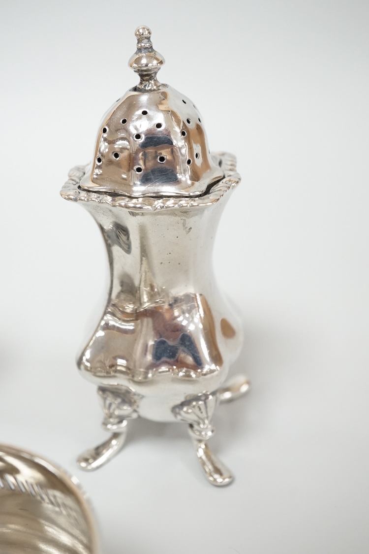Four assorted silver condiments including a Victorian bun salt and a late Victorian pepper mill, together with a small silver bowl, a silver matchbox sleeve and a small silver two handled cup.